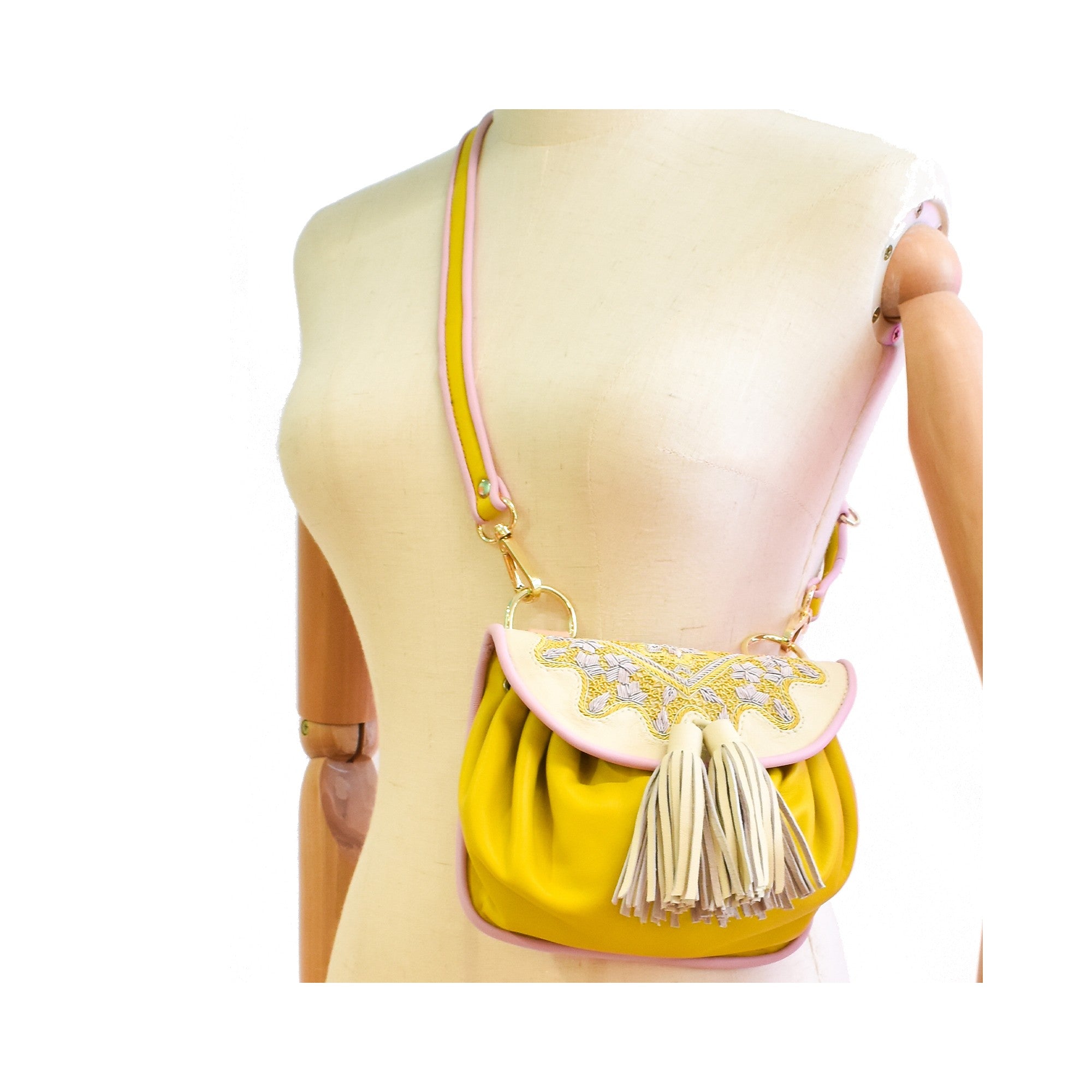 Canary yellow mini crossbody bag with polar white embroidery and pink trim.