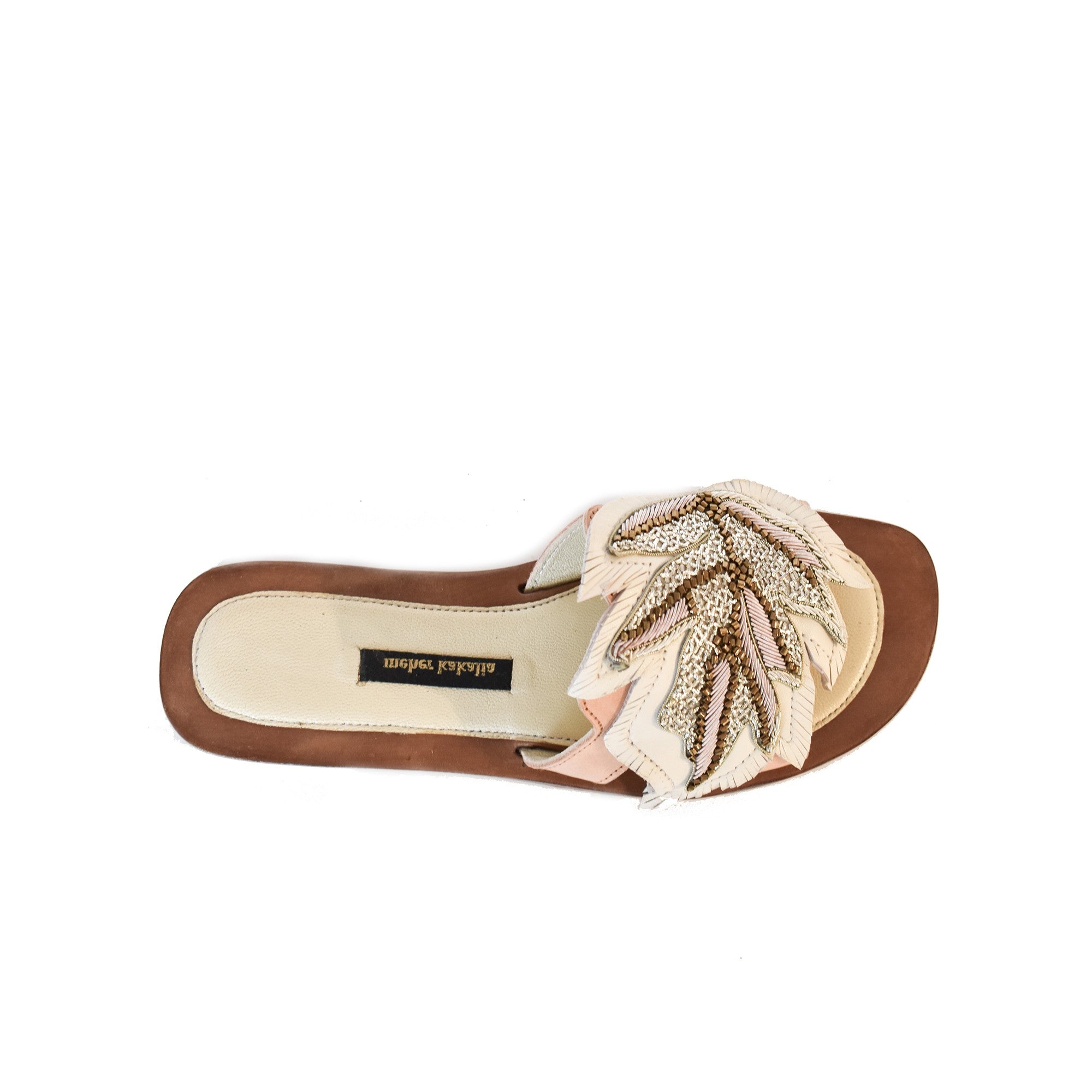 Resort wear luxury: Hand embroidered white slides, perfect for beach holidays, crafted with eco-friendly leather.