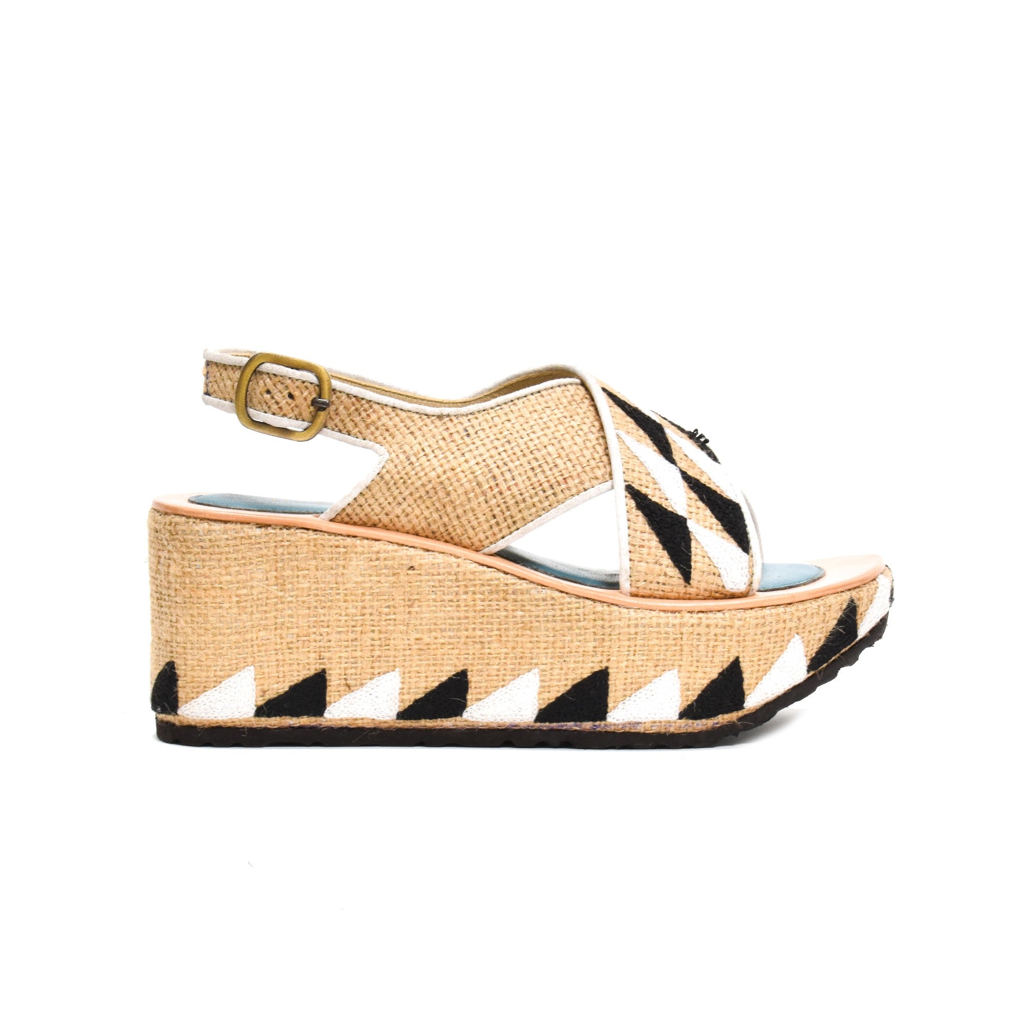 Side view of Ponza Geo Bloc sandals, with a platform wedge, adjustable buckle strap, and bold black-and-white embroidery.