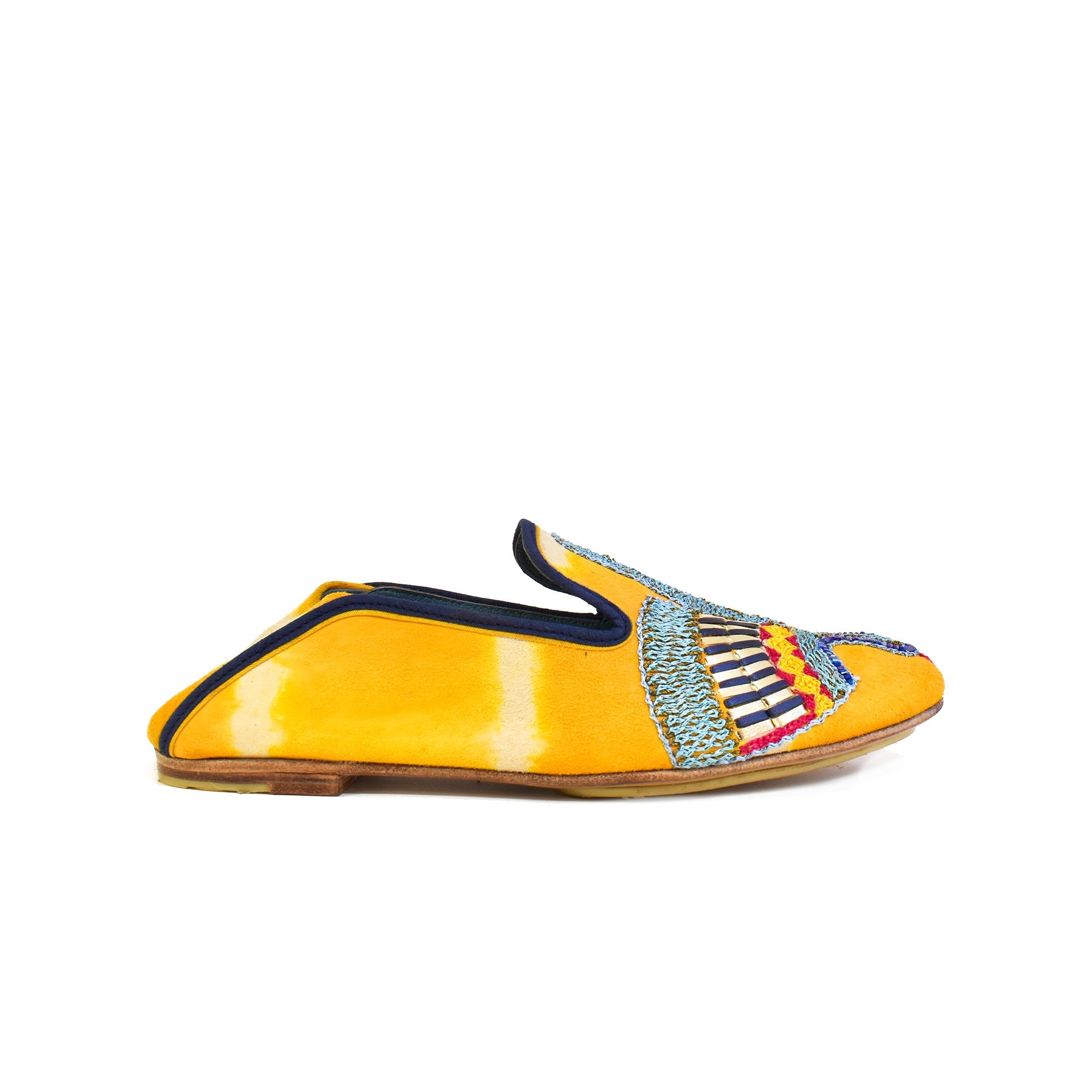 Side view of ANZU Moccasin TD saffron in yellow tie-dye suede leather with navy trim and embroidered vamp motif