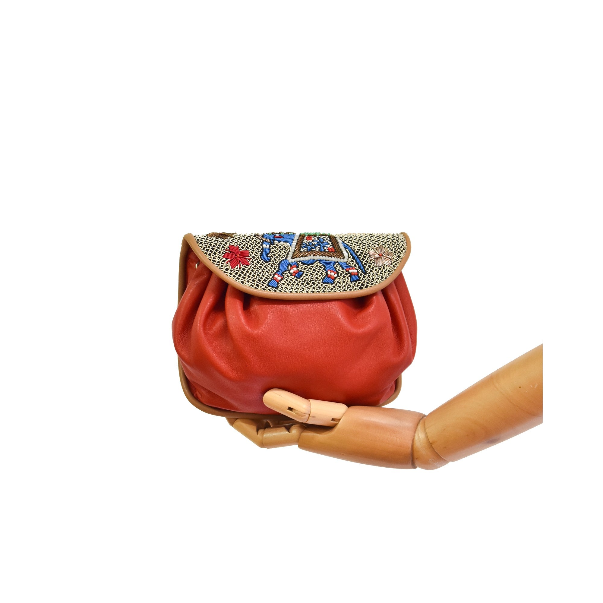 Women’s red leather shoulder bag with handcrafted embroidered flap and gold hardware.